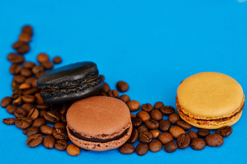 coffee beans and chocolate macaroons on a blue background with a place under the text