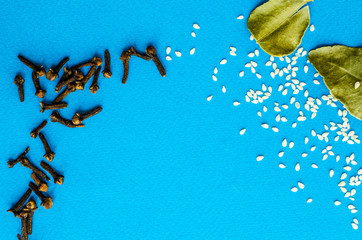 many spices on a blue background with place under the text