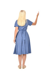 full length portrait of blonde girl wearing blue dress. standing pose with back to the camera. isolated on white  studio background.