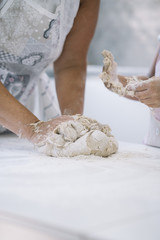 Mother and daughter making bread at home
