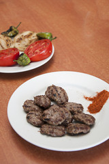 Traditional turkish meatball and roasted onion,roasted pepper, roasted tomatoes