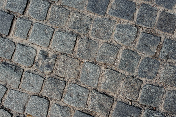 Top background macro photography of grey stone block road pavement