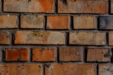 Old dirty exterior brown brick wall with lines of concrete