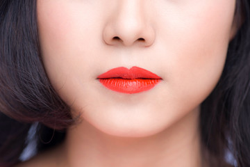 Macro of woman's face part. Red lips makeup.