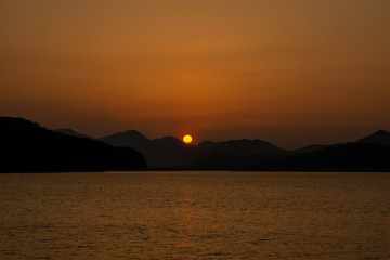 Beautiful sunset scene at the mountain and sea shore.