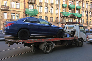 wrecker carrying a car after a road accident