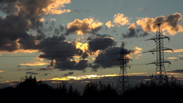 High voltage transmission power line at nature landscape by sunset.