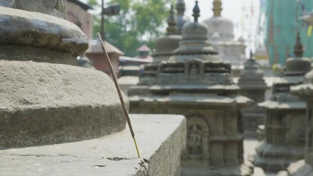 Incense smoldering in ancient Sawayambhunath monkey temple in Kathmandu, Nepal.