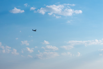 Silhouette seaplane. Flying boat on blue sky.