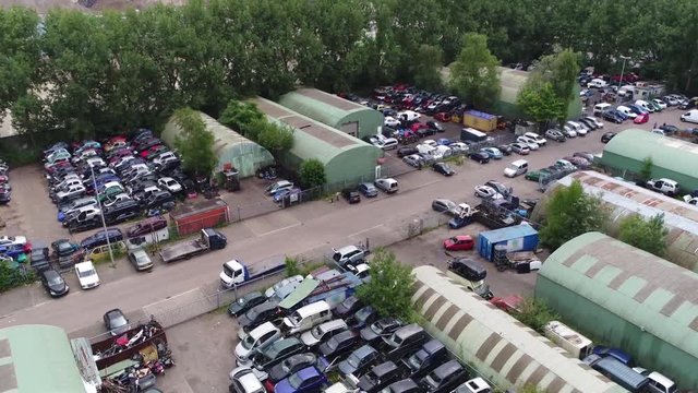 Aerial bird view of junkyard is the location of business in dismantling where wrecked or decommissioned vehicles are brought their usable parts are sold for use in operating vehicles 4k quality