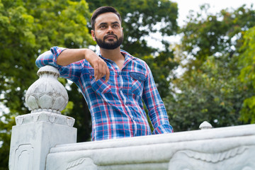 Fototapeta premium Portrait Of Young Handsome Indian Man In Park