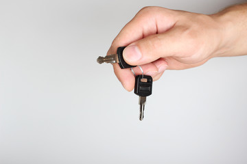 key in hand on a light background