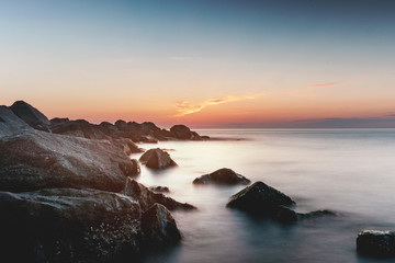 Amazing relaxing and colorful evening sunset with dramatic white clouds at a danish beach. Danish ocean sea, Lønstrup in North Jutland in Denmark, Skagerrak, North Sea