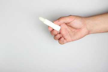 hygienic lipstick in hand