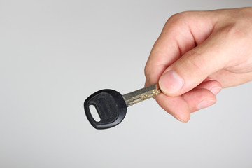 key in hand on a light background