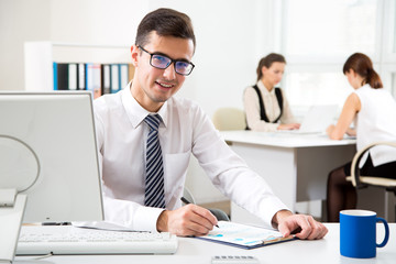 Young businessman working with computer in an office