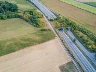 Aerial view of wildlife overpass over highway in Switzerland during sunset