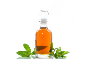 Mint syrup in a glass bottle on a white background