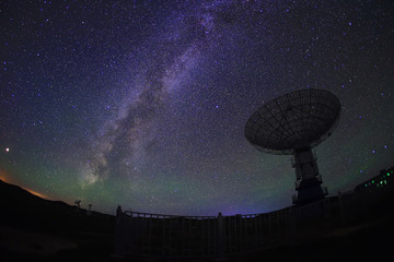 radio telescope on the background of stellar tracks