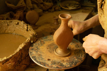 Hands of the master on clay which creates a jug. Motivation to create yourself