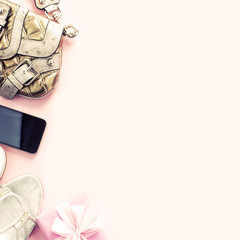 Modern fashion accessories young women shoes handbag phone gadget gift box pink background.