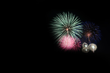 colorful fireworks on the black sky background over-water