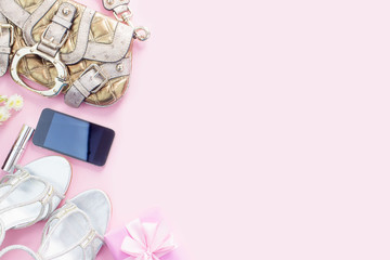 Modern fashion accessories young women shoes handbag phone gadget gift box pink background.