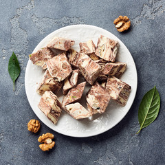 Oriental sweet dessert. Eastern halva on a white plate. Top view.