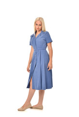 full length portrait of blonde girl wearing blue dress. standing pose. isolated on white  studio background.