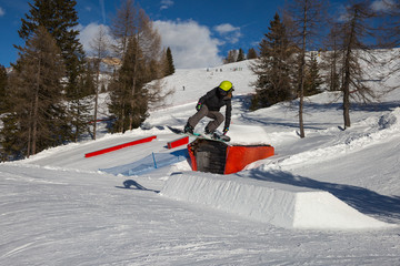 Snowboarder in Action: Jumping in the Mountain Snowpark
