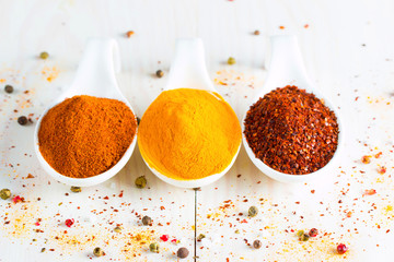 Spices in Wooden spoon. Herbs. Curry, Saffron, turmeric, rosemary, cinnamon, garlic, pepper, anise...