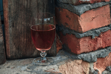 Red and white wine glasses with green leaves on white background