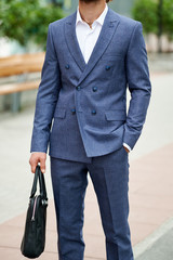 Businessman style. Men style. Man in custom tailored business suit posing outdoors