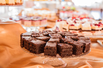 Selection of cakes and pastry set up on cake stands for a party