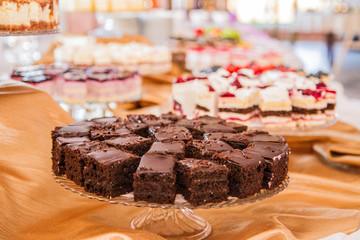 Selection of cakes and pastry set up on cake stands for a party