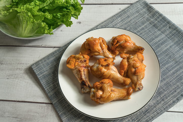 Roast chicken wring on the wooden table