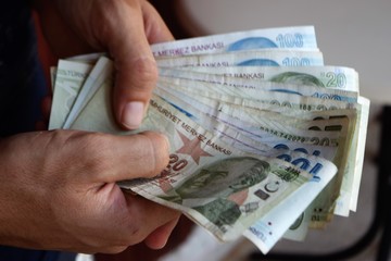 Turkish Lira in man hands