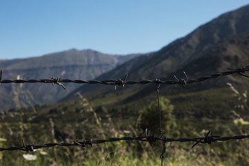 mountains beyond the barbed wire. Entry is prohibited.