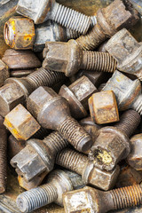 Used old oily wheel bolts, wheel nuts, texture background
