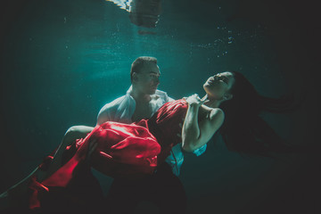 Fototapeta na wymiar Couple swimming underwater