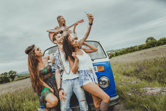 Happy friends driving a vintage minivan