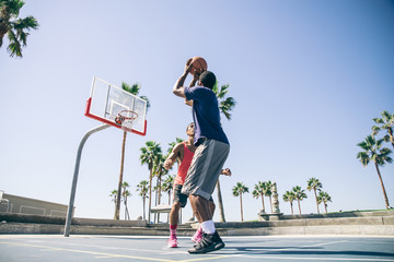 Fototapeta premium Friends playing basketball