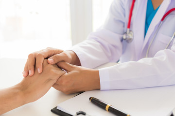 Doctor holding patient's hand. Medicine and health care concept. Doctor and patient.