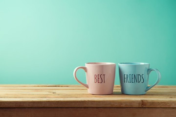 Coffee cups on wooden table - obrazy, fototapety, plakaty