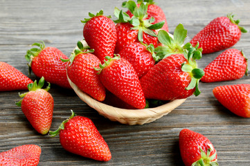 Colorful of fresh Strawberry in the basket on wooden background.