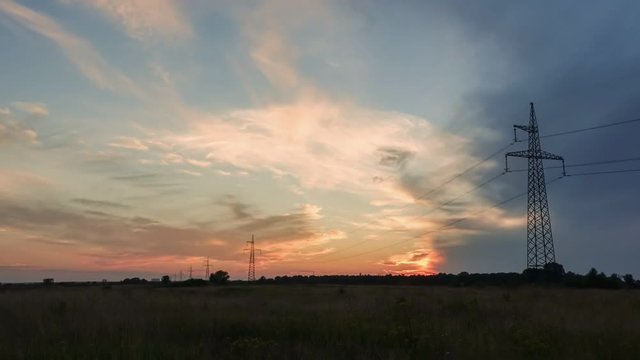 Time Lapse of a sunset with Electrical cables and utility poles. Video footage in Full HD
