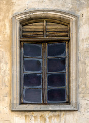 The texture of the old window with a rusty grille