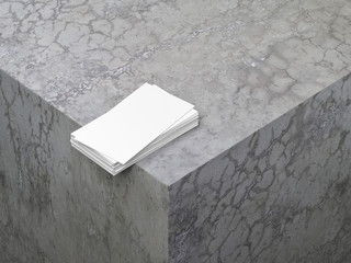 Stack of White textured business cards mockup on concrete cube