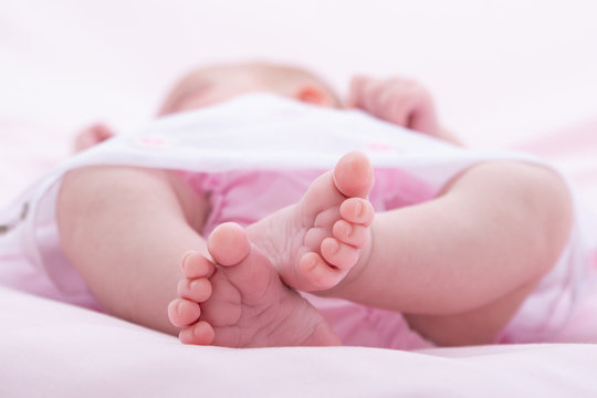 feet of newborn in perspective on white background