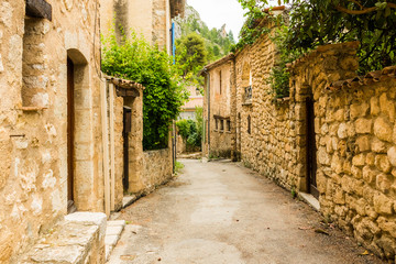 Fototapeta na wymiar Old medieval street with old houses of charming village Moustiers Sainte Marie, Verdon, Provence in France